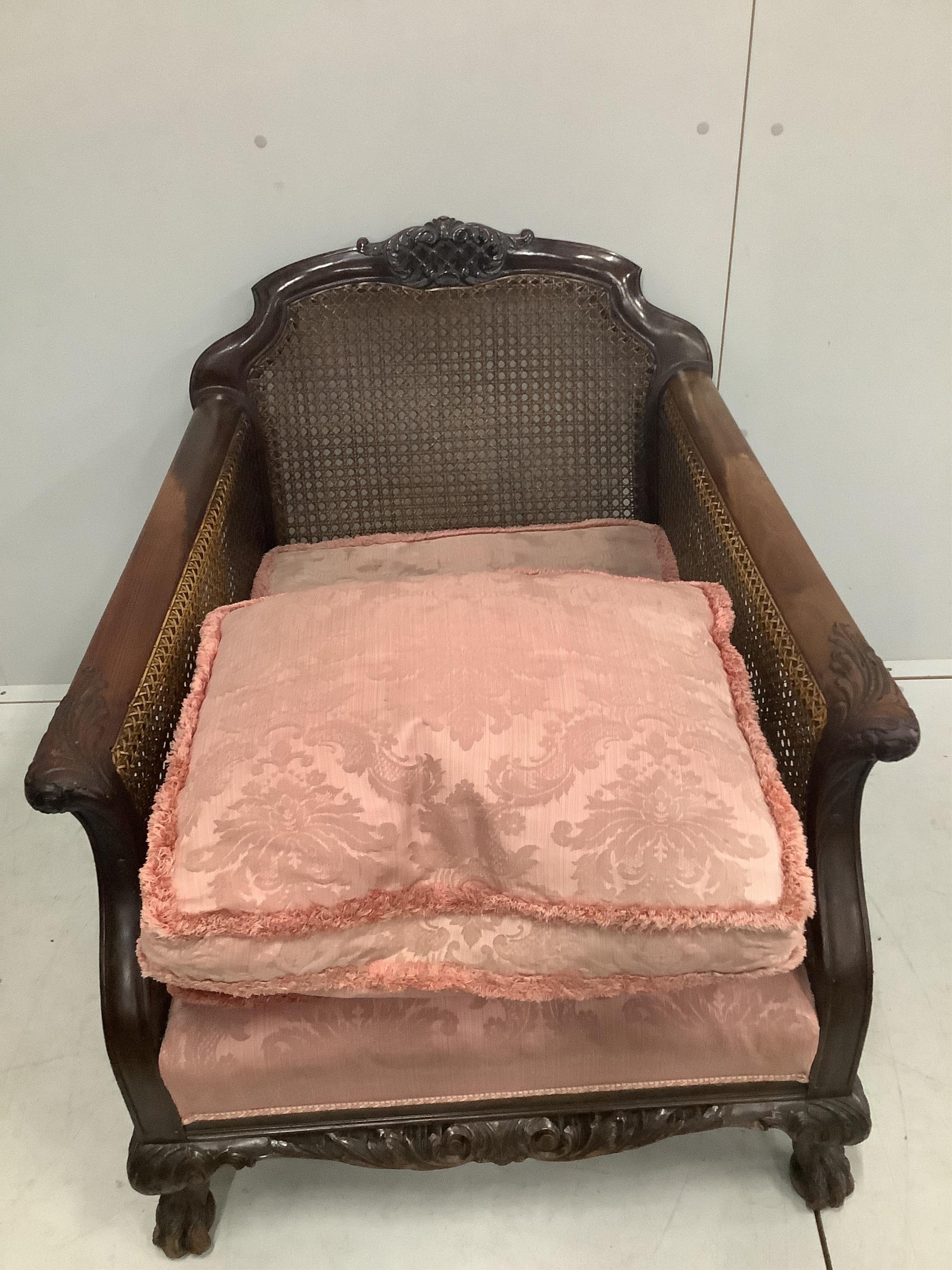 A 1930's mahogany three piece Bergere suite, with double caned arms and single caned backs. Condition - some fading with small damages to the caning